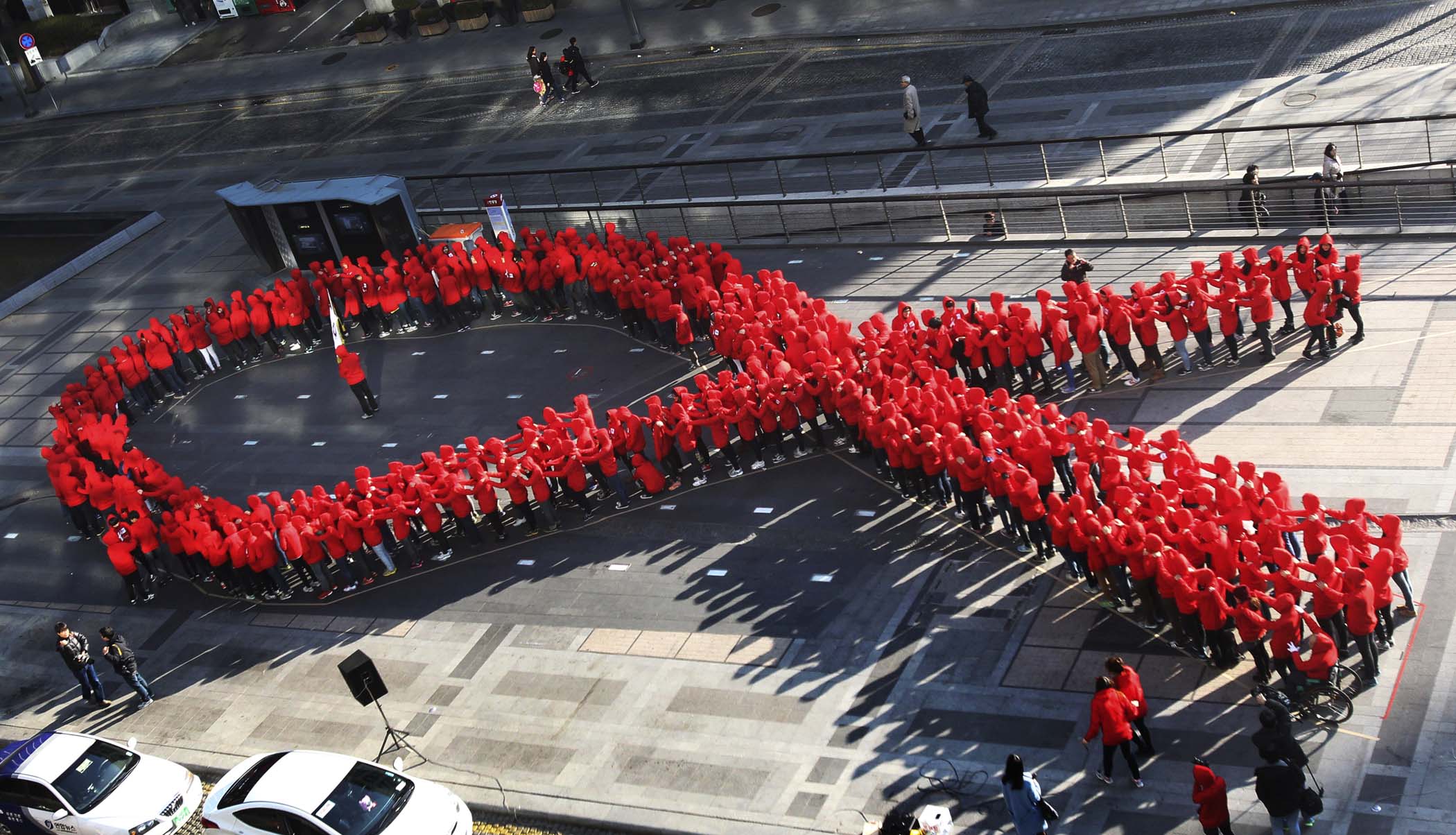 High school students make a formation in the shape of a red ribbon during a campaign to mark World AIDS Day in Seoul, South Korea. (Ahn Young-joon/Associated Press)